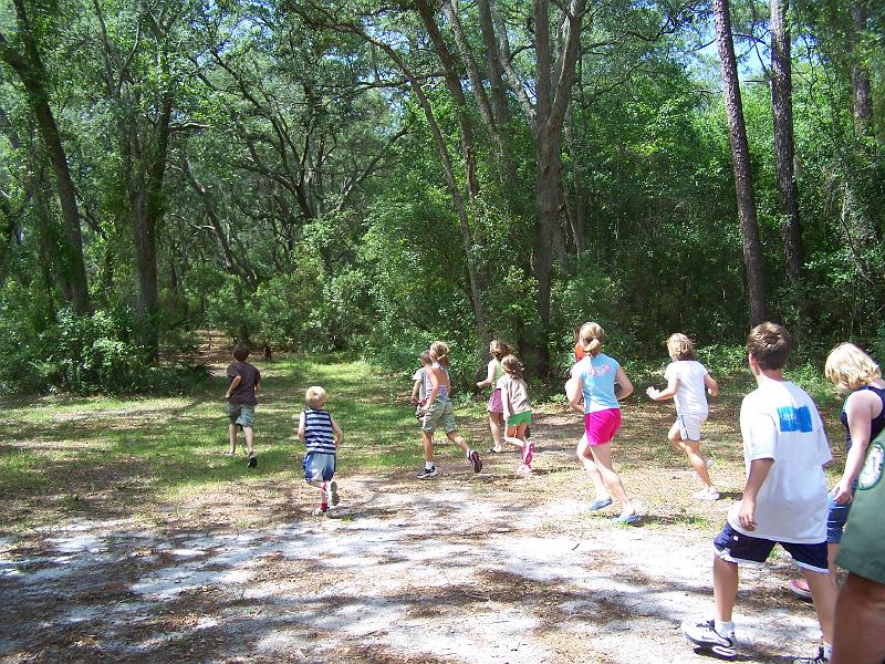 100_6920.JPG - And the're off.  The kids run after the dog as he begins his search.